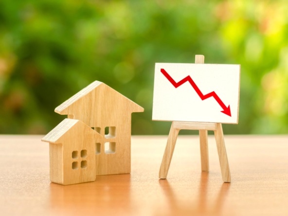 Wooden house and board showing economic woes